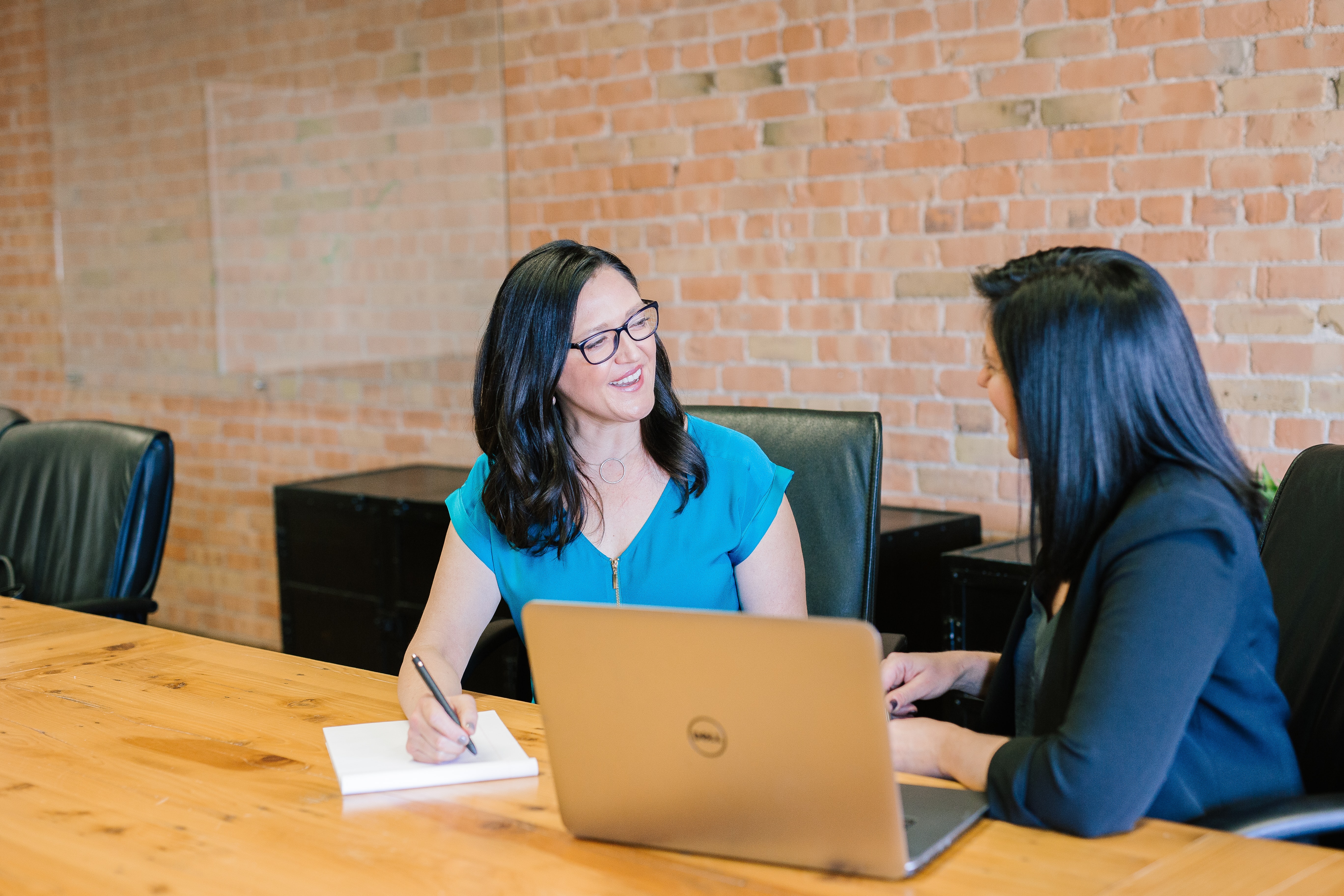 two women talking in a office
